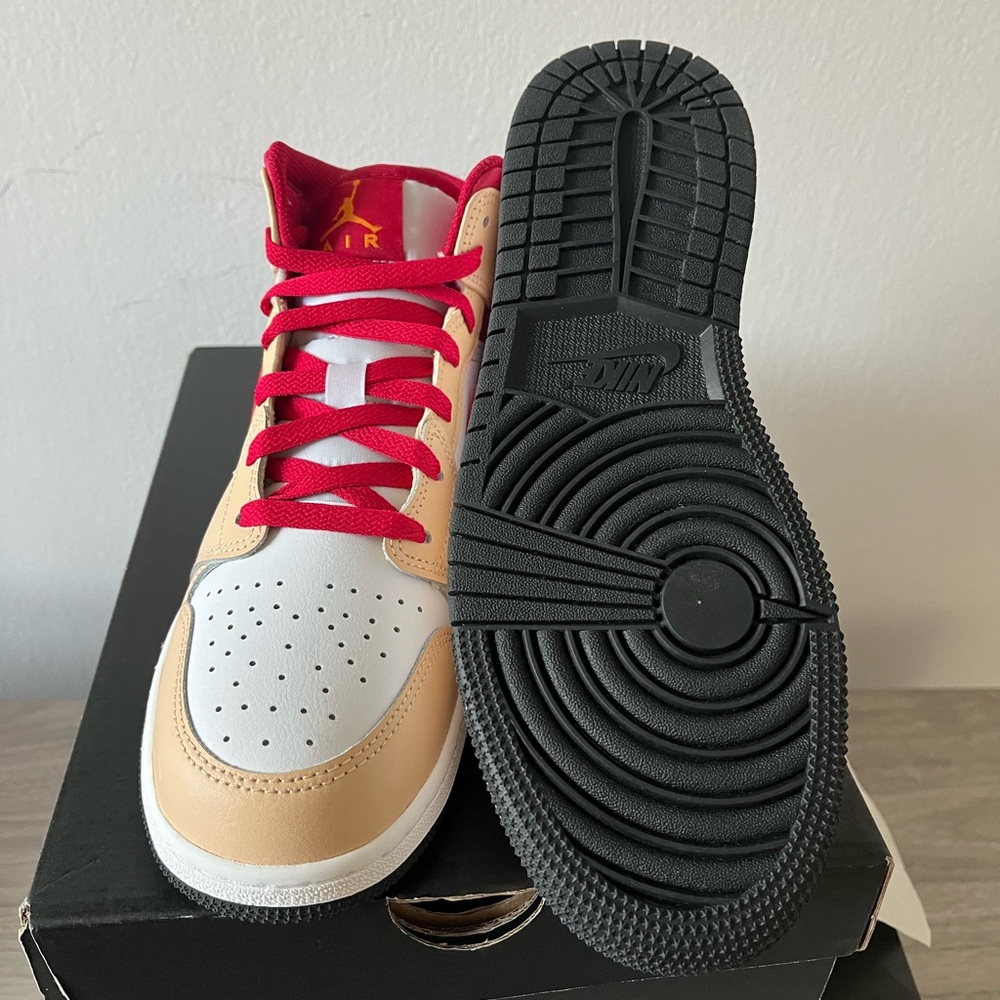 White, tan, and red Jordan one’s